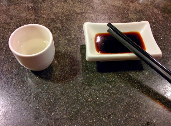 sake, soy  sauce, and chopsticks